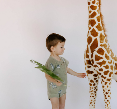 18 month old wearing zebra print knit playsuit in sage