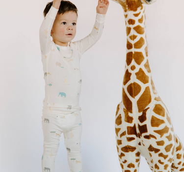 Little boy wearing modal toddler pajama set in zoo print