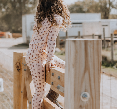 little girl wearing modal pajama set in light pink color with rose floral pattern