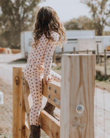 little girl wearing modal pajama set in light pink color with rose floral pattern