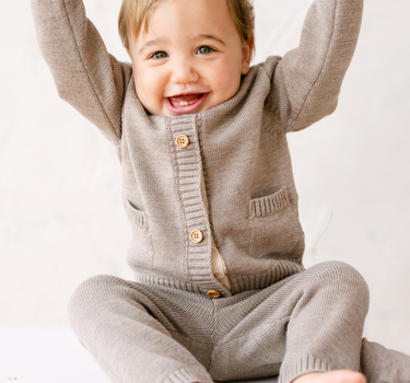 image shows baby boy wearing merino wool baby cardigan in heather brown