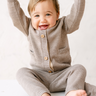 image shows baby boy wearing merino wool baby cardigan in heather brown