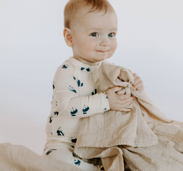 baby boy wearing modal footy pajamas in panda print