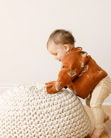 Image shows baby boy wearing organic cotton knit sweater with fox jacquard pattern in mocha. 