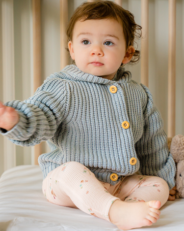 Image shows baby girl wearing pima cotton knit hoody in pearl blue. 