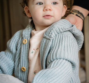 Image shows baby girl wearing pima cotton knit hoody in pearl blue. 