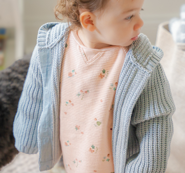 Image shows baby girl wearing pima cotton knit hoody in pearl blue. 