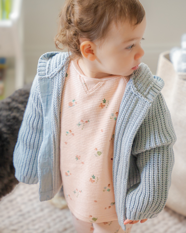 Image shows baby girl wearing pima cotton knit hoody in pearl blue. 