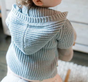 Image shows baby girl wearing pima cotton knit hoody in pearl blue. 