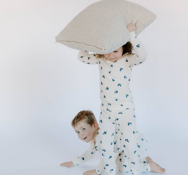 Image shows kids wearing modal pajamas in panda print.