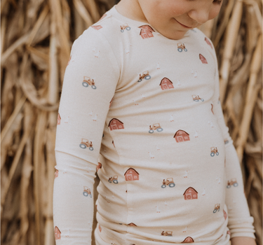 little boy wearing modal pajama set in farm print