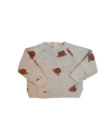 Image shows flat lay image of organic cotton knit sweater with snail jacquard pattern in oatmeal. 