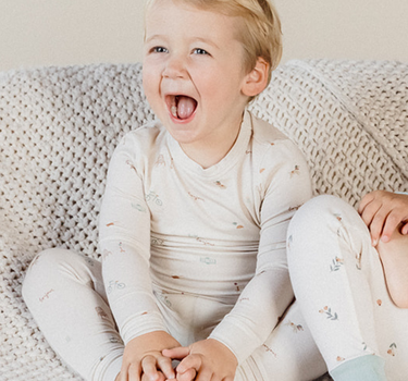 Image shows toddler boy wearing modal pajama set in Paris print.