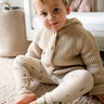 Image shows toddler boy wearing pima cotton knit waffle hoody in oatmeal. 