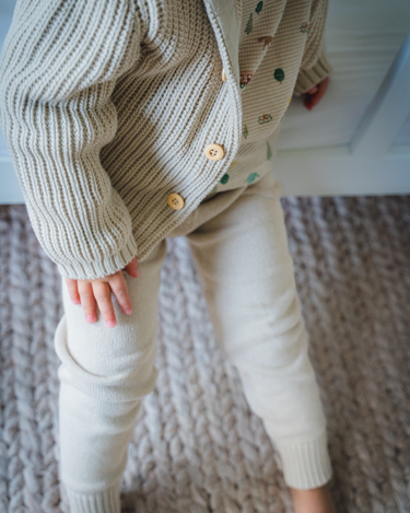 Image shows toddler boy wearing pima cotton knit waffle hoody in oatmeal. 