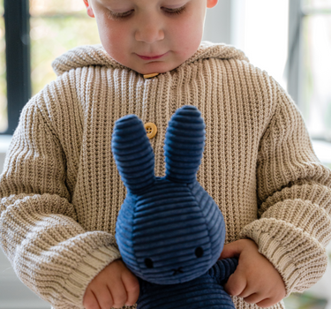 Image shows toddler boy wearing pima cotton knit waffle hoody in oatmeal. 