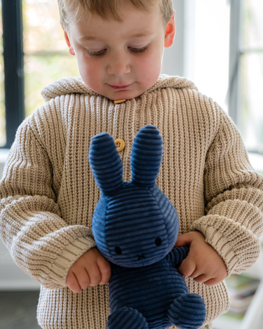 Image shows toddler boy wearing pima cotton knit waffle hoody in oatmeal. 