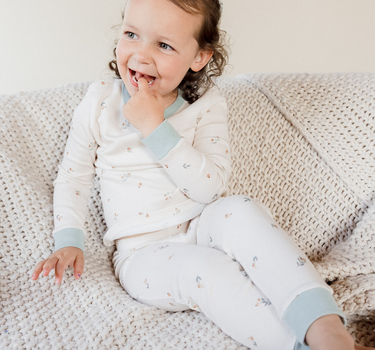 Image shows toddler girl wearing organic cotton modal rib toddler pajama set in floral bud. 